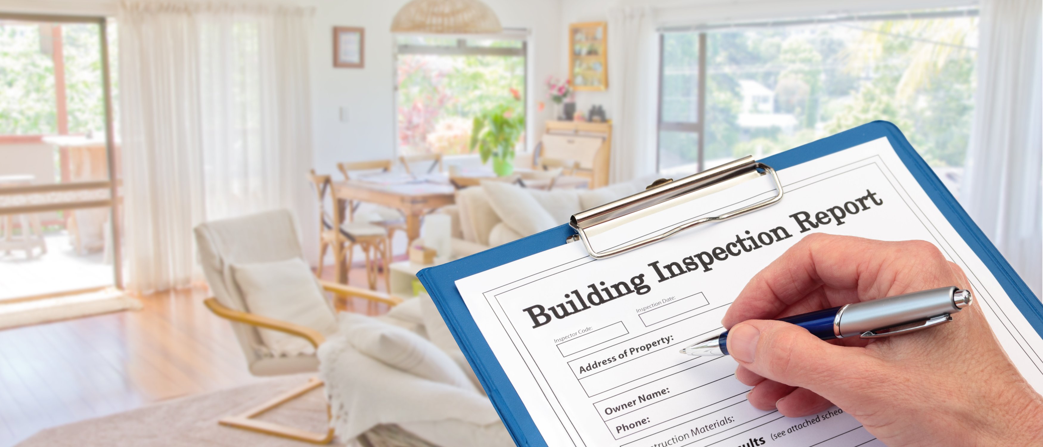 Banner Building Inspector completing an inspection form on clipboard